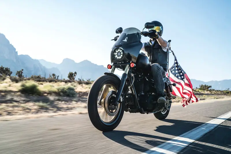 riding a harley davidson with american flag