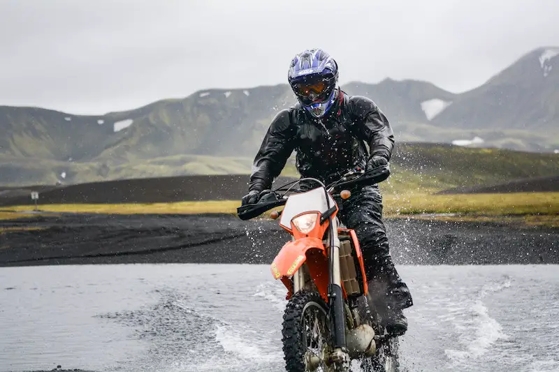 riding a dual sport bike through a river