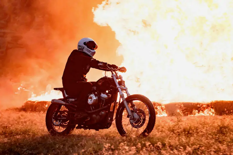 motorcycle riding past a fire