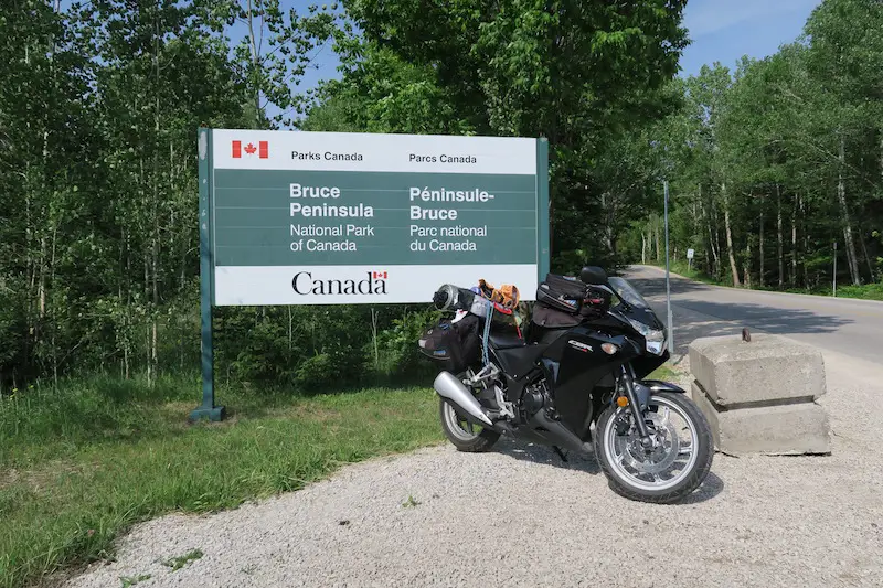 Taking Photos with my motorcycle at the Bruce Peninsula National Park entrance sign into the campground