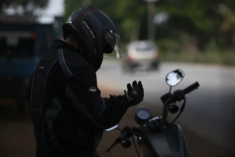 putting motorbike gloves on