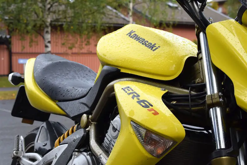 A motorcycle sitting out in the rain